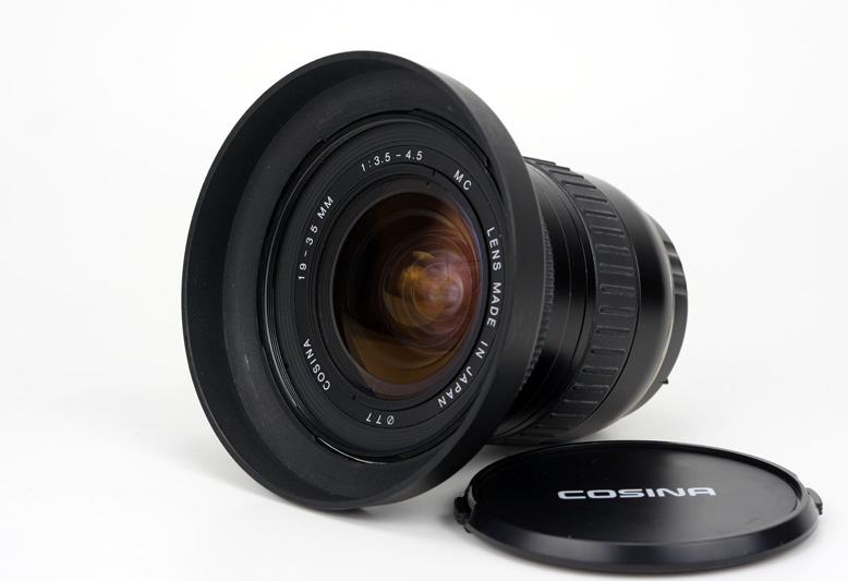Cosina AF 19-35mm F3.5-4.5 for Canon EF Complete Set showing the dedicated lens hood, multi coatings, model name inscription and filter size